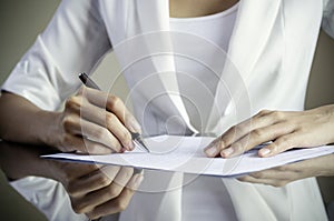 A woman signing a contract